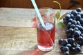 Fresh Grape juice by some Grape vines. brush of black grape juice fresh organic on wooden surface, copy space