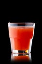 Fresh grapefruit juice in rocks glass isolated on black Royalty Free Stock Photo