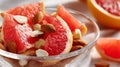 Fresh grapefruit slices with crunchy almonds and walnuts in glass bowl Royalty Free Stock Photo
