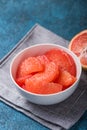 Fresh grapefruit slices in a wooden bowl, healthy snack Royalty Free Stock Photo