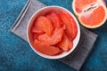 Fresh grapefruit slices in a wooden bowl, healthy snack Royalty Free Stock Photo