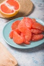 Fresh grapefruit slices in a wooden bowl, healthy snack Royalty Free Stock Photo