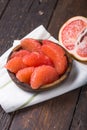 Fresh grapefruit slices in a wooden bowl, healthy snack Royalty Free Stock Photo