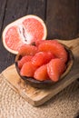 Fresh grapefruit slices in a wooden bowl, healthy snack Royalty Free Stock Photo