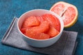 Fresh grapefruit slices in a wooden bowl, healthy snack Royalty Free Stock Photo