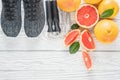 Fresh grapefruits and grapefruit juice and rope on rustic white wooden table, fitness accessories. Concept of slimming, dieting Royalty Free Stock Photo