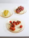 Fresh grapes, cherry tomatoes and carambola on plates