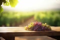 fresh grapes fruits bunch on wooden table with vineyard field on morning sunshine background with copyspace area,Generative AI