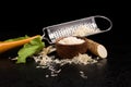 Fresh grated horseradish roots and grater. Royalty Free Stock Photo