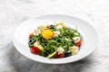 Fresh greek salad arugula, cream cheese, pine nuts, tomato, black olives and cucumber. healthy vegan lunch bowl. banner, menu Royalty Free Stock Photo