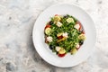 Fresh greek salad arugula, cream cheese, pine nuts, tomato, black olives and cucumber. healthy vegan lunch bowl. banner, menu Royalty Free Stock Photo