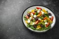 Fresh Greek salad with cucumber, cherry tomato, lettuce, red onion, feta cheese and black olives. Healthy food Royalty Free Stock Photo