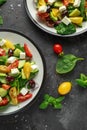 Fresh Greek salad with cucumber, cherry tomato, lettuce, red onion, feta cheese and black olives. Healthy food Royalty Free Stock Photo