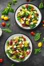 Fresh Greek salad with cucumber, cherry tomato, lettuce, red onion, feta cheese and black olives. Healthy food Royalty Free Stock Photo