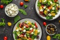 Fresh Greek salad with cucumber, cherry tomato, lettuce, red onion, feta cheese and black olives. Healthy food Royalty Free Stock Photo