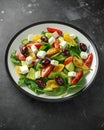 Fresh Greek salad with cucumber, cherry tomato, lettuce, red onion, feta cheese and black olives. Healthy food Royalty Free Stock Photo