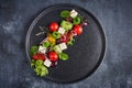 Fresh greek salad with tomato, cucumber, bel pepper , olives and feta cheese on black plate Royalty Free Stock Photo