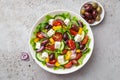 Fresh greek salad  tomato, cucumber, bel pepper, olives  and feta cheese in white bowl Royalty Free Stock Photo