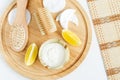 Fresh greek yogurt, lemon, cotton eye patches, wooden hair brush and body brush. Ingredients for preparing homemade facial mask