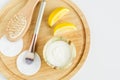 Fresh greek yogurt, lemon, make-up brush, cotton pads and wooden hair brush. Ingredients for preparing homemade face and hair mask