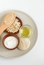 Fresh greek yogurt, oatmeal, olive oil, wooden haibrush and body brush. Natural skin care and zero waste concept. Top view