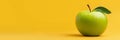 A fresh green apple sits on a vibrant yellow background offering a clean and simple composition with ample copy space The apple Royalty Free Stock Photo