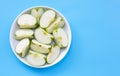 Fresh green apple slices on white plate on blue background. Top view Royalty Free Stock Photo