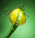 Fresh green apple in Water splashing stream on on Green backgrou Royalty Free Stock Photo