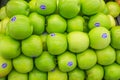 Green apple are displayed on a tray in the supermarket. Fresh food for health and diet