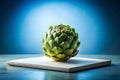 Fresh Green Artichoke on White Slab with Blue Background Royalty Free Stock Photo
