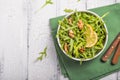 Fresh green arugula leaves on white bowl, rucola rocket salad on wooden rustic background with place for text. Selective focus, Royalty Free Stock Photo