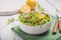 Fresh green arugula leaves on white bowl, rucola rocket salad on wooden rustic background with place for text. Selective focus, Royalty Free Stock Photo