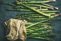 Fresh green asparagus in craft paper bag over grey background Royalty Free Stock Photo