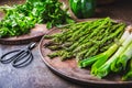 Fresh green asparagus with green onion and herbs on wooden table Royalty Free Stock Photo