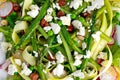 Fresh Green Asparagus salad witch Goat Cheese, peas, radishe, zucchini, lettuce and Hazelnuts. Royalty Free Stock Photo