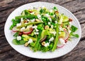 Fresh Green Asparagus salad witch Goat Cheese, peas, radishe, zucchini, lettuce and Hazelnuts. Royalty Free Stock Photo