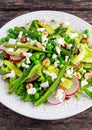 Fresh Green Asparagus salad witch Goat Cheese, peas, radishe, zucchini, lettuce and Hazelnuts. Royalty Free Stock Photo