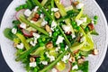 Fresh Green Asparagus salad witch Goat Cheese, peas, radishe, zucchini, lettuce and Hazelnuts. Royalty Free Stock Photo