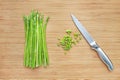 Fresh green asparagus and sliced on wooden board background with sharp knife Royalty Free Stock Photo