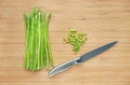 Fresh green asparagus and sliced on wooden board background with sharp knife Royalty Free Stock Photo