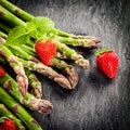 Fresh green asparagus spears and strawberries Royalty Free Stock Photo