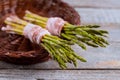 Fresh green asparagus wrapped with bacon in the basket Royalty Free Stock Photo