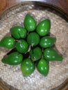 Fresh green avocados are artfully arranged on a large plate, ready to be savored