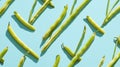 Fresh green beans pattern on a vibrant turquoise background Royalty Free Stock Photo