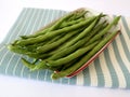 fresh green beans on a rectangular plate with a blue cloth underneath Royalty Free Stock Photo