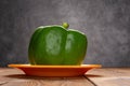 Fresh green bell pepper with drips on table Royalty Free Stock Photo