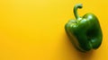 Fresh Green Bell Pepper on Vibrant Yellow Background