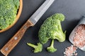 Fresh broccoli with knife on bleck table