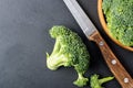 Fresh broccoli with knife on bleck table