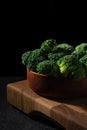 Fresh green broccoli on a wooden butt cutting board